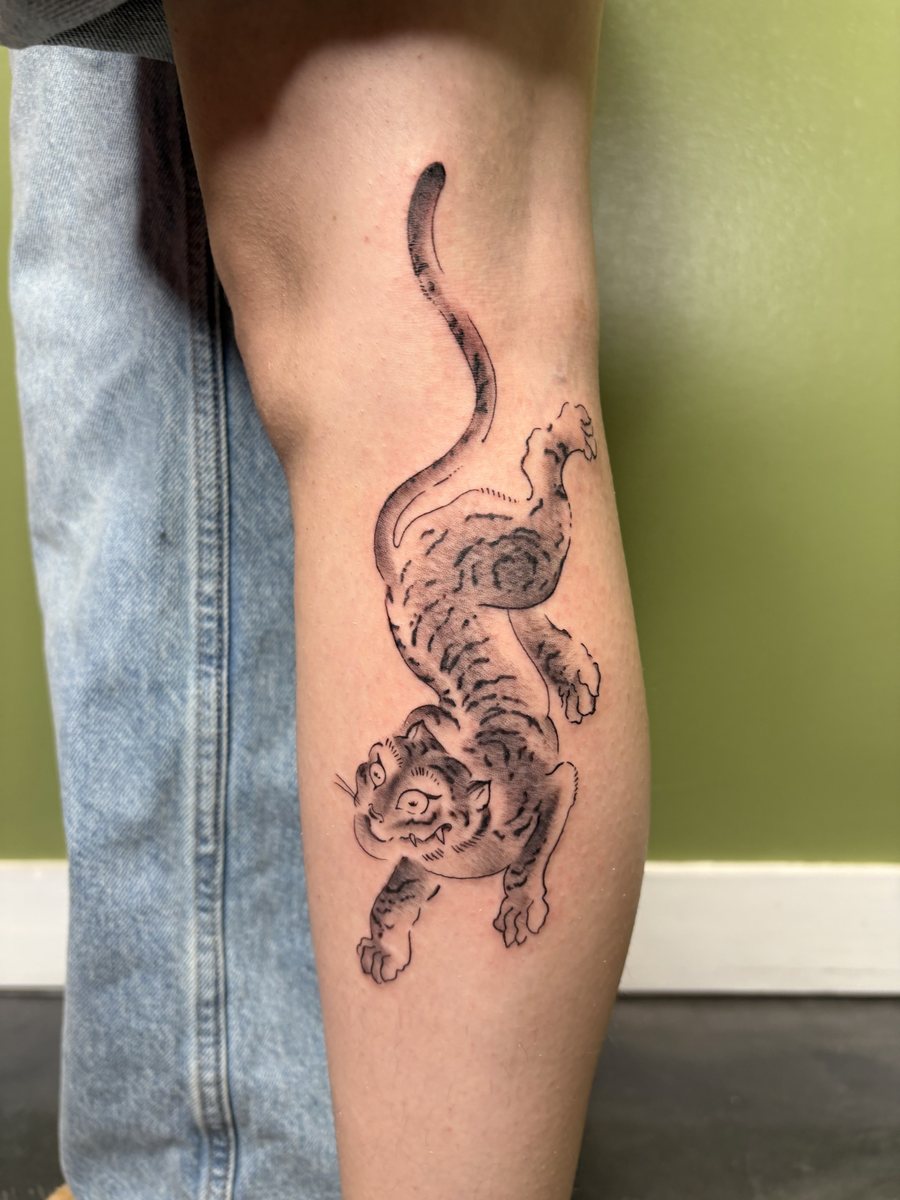 Black and grey tiger tattoo on the lower leg
